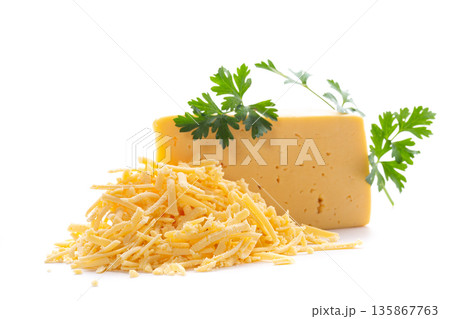Fresh yellow cheese with grated pieces and green garnish 135867763