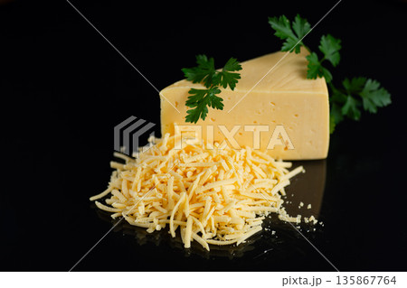 Gourmet dairy cheese with shredded texture and green herbs 135867764