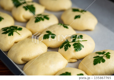 Homemade yeast dough rolls with parsley before baking 135867765