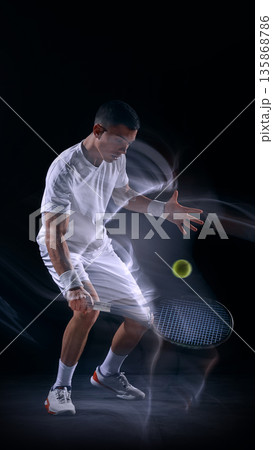Tennis player forehand strike with light trails on dark background. 135868786