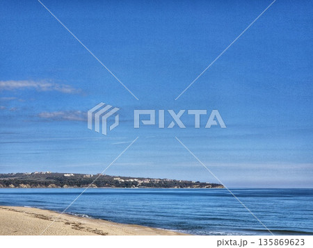 Deep Blue Seascape with Coastline.Tropical Coast and Blue Sky. Quiet Beach and Cape on the Horizon Deep Blue Seascape with Coastline.Tropical Coast and Blue Sky. Quiet Beach and Cape on the Horizon 135869623