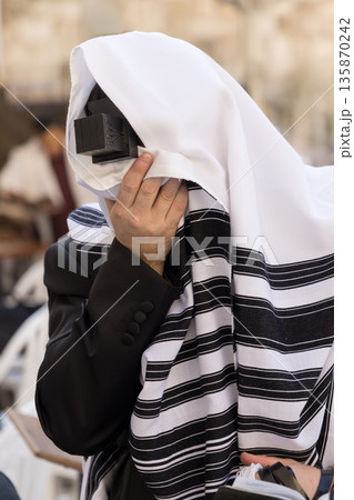 Jewish Man Praying at the Western Wall in Jerusalem 135870242