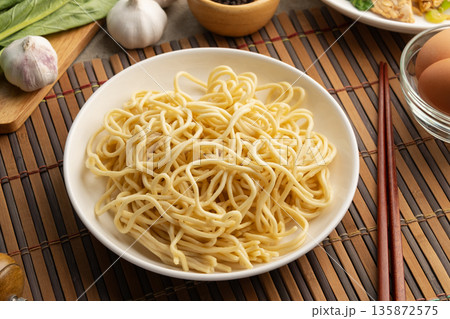 Raw yakisoba noodles in white plate,made from wheat flour and egg. 135872575