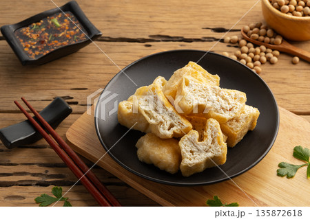Deep fried tofu in black plate. Deep fried tofu in black plate. 135872618