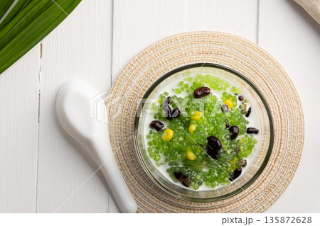 Pandan flavoured Black bean and corn Tapioca pearl pudding (Sago) with a dash of coconut milk 135872628