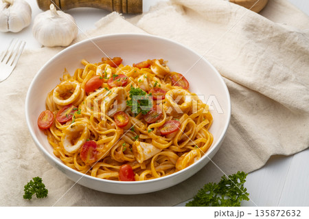 Linguine pasta with squid and cherry tomato Linguine pasta with squid and cherry tomato 135872632