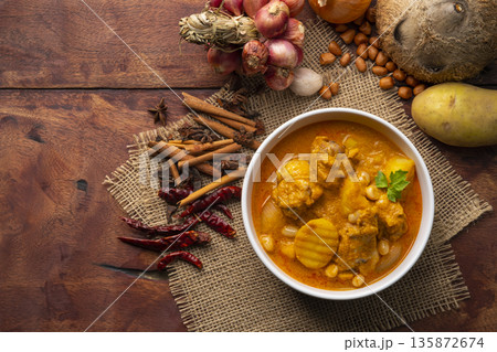 Massaman Curry with Chicken and Potatoes.It is an aromatic curry with a tangy, luxurious taste that is harmonic, sweet and isn't as spicy.Top view Massaman Curry with Chicken and Potatoes.It is an aromatic curry with a tangy, luxurious taste that is harmonic, sweet and isn't as spicy.Top view 135872674