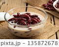 Boiled red beans in coconut milk and sugar in glass bowl,Thai Dessert on wooden table 135872678