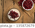 Boiled red beans in coconut milk and sugar in glass bowl,Thai Dessert on wooden table.Top view. 135872679