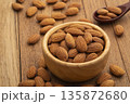 Dry roasted Almonds in wooden bowl on wooden table.Heap of almond. 135872680