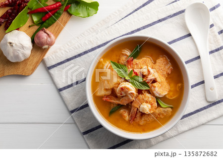 Red curry Pineapple and shrimp in white bowl.(Kang Kua Subpharod Kung) Thai food.Top view. Red curry Pineapple and shrimp in white bowl.(Kang Kua Subpharod Kung) Thai food.Top view. 135872682