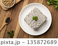 Tofu mix black sesame seeds in white plate on wooden table.Top view 135872689