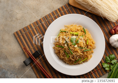 Stir Fried Rice Vermicelli Noodles With Tamarind Sauce in white plate.Top view.copy space. 135872691