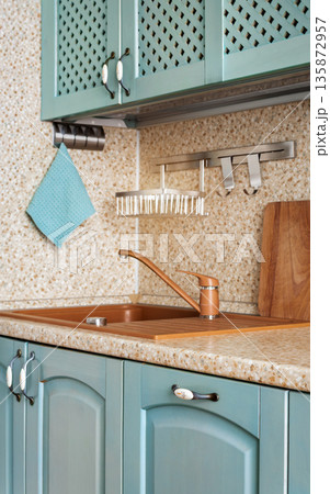Cozy kitchen sink corner with countertop and cabinets Cozy kitchen sink corner with countertop and cabinets 135872957