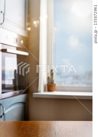Bright kitchen interior with wooden table and window copy space 135872961