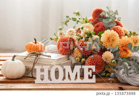 Autumn composition with a bouquet of chrysanthemums and decorative word home. Autumn composition with a bouquet of chrysanthemums and decorative word home. 135873898