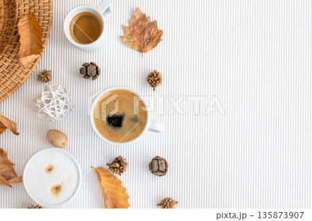Autumn composition with cups of coffee and leaves on a white background. 135873907