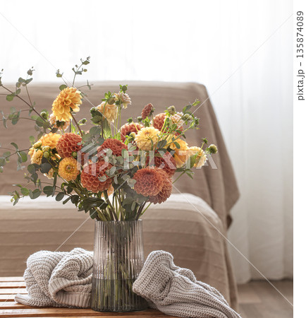 Bouquet of chrysanthemums in a vase in the interior of the room, copy space. 135874089