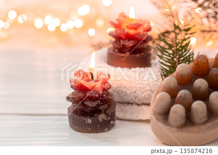 Christmas spa composition with incense sticks and soap on a blurred background. Christmas spa composition with incense sticks and soap on a blurred background. 135874216