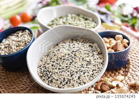 Close-up, a bowl of chia seeds and other healthy foods on the kitchen table. 135874245