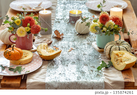 Festive table setting with pumpkins and chrysanthemum flowers. 135874261