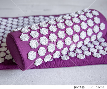 Massage acupuncture mat with pillow and white massage tips. 135874284