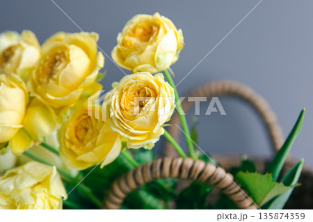 Close-up of yellow spring flowers in a basket. Close-up of yellow spring flowers in a basket. 135874359