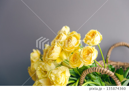 Close-up of yellow spring flowers in a basket. Close-up of yellow spring flowers in a basket. 135874360