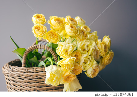 Close-up of yellow spring flowers in a basket. Close-up of yellow spring flowers in a basket. 135874361
