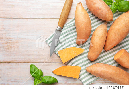 Preparing raw sweet potatoes for healthy cooking Preparing raw sweet potatoes for healthy cooking 135874574