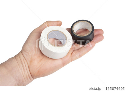 a roll of white and black electrical tape on the palm of your hand a roll of white and black electrical tape on the palm of your hand 135874695