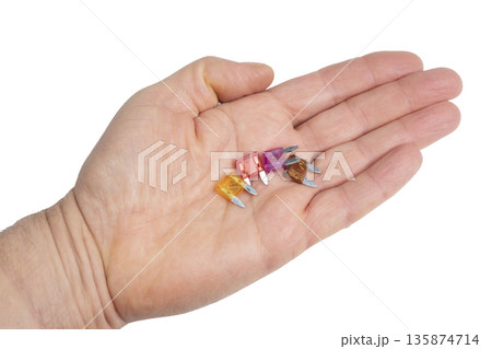 some car fuses in the palm of your hand some car fuses in the palm of your hand 135874714