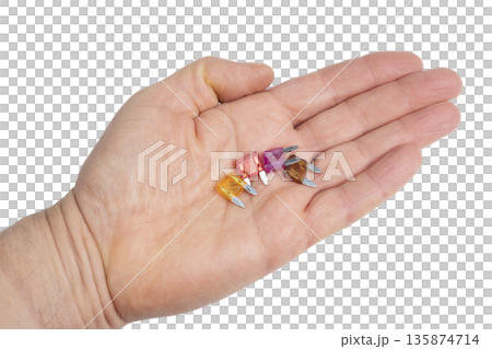 some car fuses in the palm of your hand 135874714