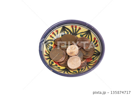 a bowl decorated with some euro coins 135874717