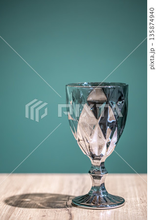 Shiny textured glass on a light blue background. Shiny textured glass on a light blue background. 135874940