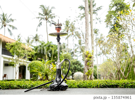 smoking hookah on vacation smoking hookah on vacation 135874961