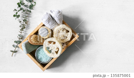Spa composition with care products in a wooden box on white isolated. 135875001