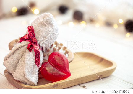 Spa composition with heart shaped soap towel close up. 135875007