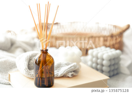 Spa composition with incense sticks and knitted element on a blurred background. Spa composition with incense sticks and knitted element on a blurred background. 135875128