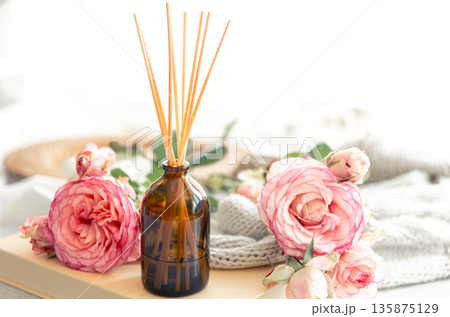 Spa composition with incense sticks and pink flowers. 135875129