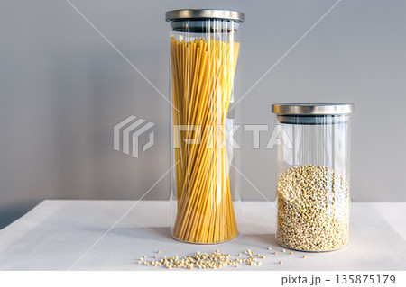 Spaghetti and cereals in glass jars, isolated. Spaghetti and cereals in glass jars, isolated. 135875179
