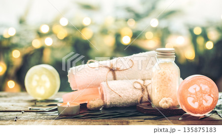 Spa handmade soap with white towels and sea salt, the composition of the tropical leaves with a candle, wooden background 135875183