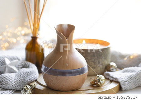 Still life with an aroma diffuser for moisturizing the air and winter decor. 135875317