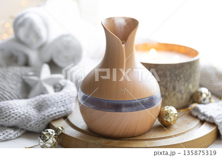 Still life with an aroma diffuser for moisturizing the air and winter decor. Still life with an aroma diffuser for moisturizing the air and winter decor. 135875319