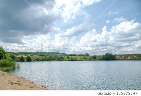 Beautiful landscape, river, forest and clouds on a sunny day. 135875347