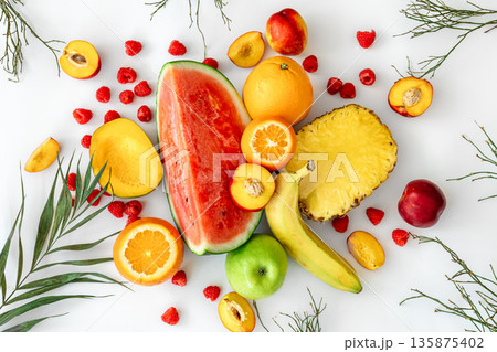 Tropical fruits on a white background top view. 135875402
