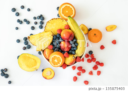 Tropical fruits on a white background top view. 135875403