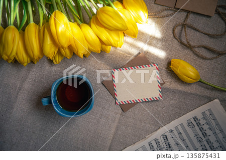 Vintage composition with a cup of tea, tulips and notes, flat lay. 135875431