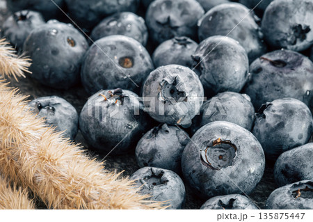 Wet ripe blueberries close up, macro shot. 135875447
