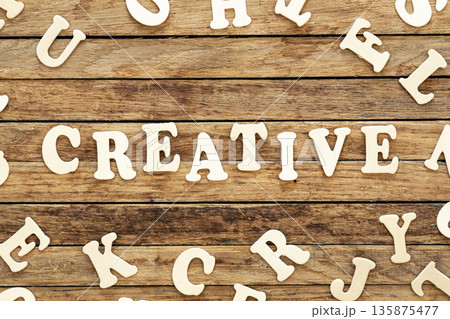 The word Creative written on wood letters on wooden background, top view. 135875477